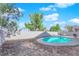 Backyard pool surrounded by bark landscaping and lush green trees at 2196 Pescara Ct, Las Vegas, NV 89123