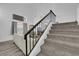 Carpeted stairs and a black metal railing lead to the upper floors of this home at 2196 Pescara Ct, Las Vegas, NV 89123