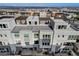 Aerial view of community, highlighting homes with rooftop decks and mountain views at 651 Sentinel Spire St, Las Vegas, NV 89138