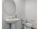 Modern powder room with pedestal sink and circular mirror at 651 Sentinel Spire St, Las Vegas, NV 89138