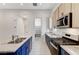 Modern kitchen with blue cabinets, granite counters, and stainless steel appliances at 651 Sentinel Spire St, Las Vegas, NV 89138