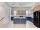 Modern kitchen with blue cabinetry, granite countertops, and stainless steel appliances at 651 Sentinel Spire St, Las Vegas, NV 89138