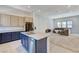 Open concept kitchen with island, stainless steel appliances, and living room view at 651 Sentinel Spire St, Las Vegas, NV 89138