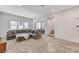 Spacious living room featuring a large sectional sofa and access to a private balcony at 651 Sentinel Spire St, Las Vegas, NV 89138