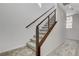 Modern staircase with wood railing and carpeted steps at 651 Sentinel Spire St, Las Vegas, NV 89138