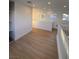 Spacious loft with wood-look floors, built-in shelving, and windows at 760 Canfield Pt Ave, Las Vegas, NV 89183