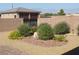 Beautifully landscaped backyard features flowerbeds, stone, and a decorative block wall at 1120 W Gray Fox Way, Pahrump, NV 89048