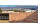 Enclosed backyard featuring a tall concrete wall, metal gate, and landscaping with mountain views at 1120 W Gray Fox Way, Pahrump, NV 89048