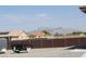 This backyard has a perimeter fence and mountain views in the distance at 1120 W Gray Fox Way, Pahrump, NV 89048