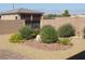Beautiful backyard with rock landscaping, mature plants, and a view of mountains at 1120 W Gray Fox Way, Pahrump, NV 89048