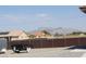 Suburban backyard with a view of houses and distant mountain range under a clear sky at 1120 W Gray Fox Way, Pahrump, NV 89048