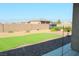 Spacious backyard featuring artificial turf and a landscaped area with a mountain view at 1120 W Gray Fox Way, Pahrump, NV 89048