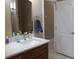 Bathroom with wood cabinets and a door leading to another room at 1120 W Gray Fox Way, Pahrump, NV 89048