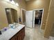 Well-lit bathroom with a marble countertop, modern fixtures, and an open doorway to a walk-in closet at 1120 W Gray Fox Way, Pahrump, NV 89048