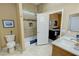 Neat bathroom featuring a tub-shower combo, marble countertop, and direct access to a living area at 1120 W Gray Fox Way, Pahrump, NV 89048