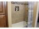 Bathtub with tan tile, shower and decorative tile accents in this well maintained bathroom at 1120 W Gray Fox Way, Pahrump, NV 89048