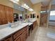 Bright bathroom with dual vanities, wooden cabinets, and a separate shower area at 1120 W Gray Fox Way, Pahrump, NV 89048