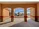 Inviting covered patio featuring three elegant archways providing a view of the front yard at 1120 W Gray Fox Way, Pahrump, NV 89048