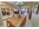 Dining area adjacent to the living room featuring a large chandelier and lots of light at 1120 W Gray Fox Way, Pahrump, NV 89048