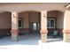 Covered entrance with decorative stone pillars, double doors, and seating at 1120 W Gray Fox Way, Pahrump, NV 89048