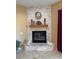 The fireplace is adorned with stacked stone and a wooden mantle adding a touch of rustic charm to the room at 1120 W Gray Fox Way, Pahrump, NV 89048