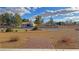 Landscaped circular driveway leading to a single-story home with a large garage and rural surroundings at 1120 W Gray Fox Way, Pahrump, NV 89048