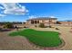 Charming single-story home with desert landscaping, artificial turf, and a brick-lined green space at 1120 W Gray Fox Way, Pahrump, NV 89048