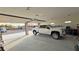 Open garage featuring a white truck and a view of the home's exterior at 1120 W Gray Fox Way, Pahrump, NV 89048