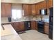 Well-lit kitchen features wood cabinetry, granite countertops, stainless appliances, and tile flooring at 1120 W Gray Fox Way, Pahrump, NV 89048