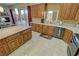 Modern kitchen featuring wooden cabinets, granite counters, tile flooring, a fireplace, and sliding glass doors to patio at 1120 W Gray Fox Way, Pahrump, NV 89048