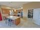 Open kitchen boasts a large island, granite countertops, stainless steel appliances, wood cabinets and walk-in pantry at 1120 W Gray Fox Way, Pahrump, NV 89048
