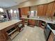 Spacious kitchen with wood cabinets, granite countertops, stainless appliances, and sliding door access to the backyard at 1120 W Gray Fox Way, Pahrump, NV 89048