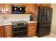 Close-up of the stainless steel oven, microwave, and refrigerator surrounded by wood cabinets and granite counters at 1120 W Gray Fox Way, Pahrump, NV 89048