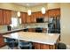 Kitchen with granite countertops, modern appliances, and breakfast bar seating at 1120 W Gray Fox Way, Pahrump, NV 89048