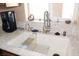 Close-up of stainless steel sink, granite countertop and window in this well-equipped kitchen at 1120 W Gray Fox Way, Pahrump, NV 89048