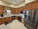 Bright kitchen featuring wood cabinetry, granite countertops, stainless steel appliances, and tile flooring at 1120 W Gray Fox Way, Pahrump, NV 89048