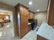 Spacious laundry room with wood cabinets, granite counters, and washer dryer set at 1120 W Gray Fox Way, Pahrump, NV 89048