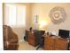 Bright home office featuring a functional desk, chair, and shutters on the window at 1120 W Gray Fox Way, Pahrump, NV 89048