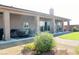 Covered patio with ceiling fans, dining area, and manicured landscaping provides outdoor entertainment at 1120 W Gray Fox Way, Pahrump, NV 89048