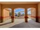 Covered patio with stone columns, offering scenic views of the front yard at 1120 W Gray Fox Way, Pahrump, NV 89048