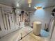 Interior view of a storage shed with various gardening tools, featuring a pegboard wall and concrete floor at 1120 W Gray Fox Way, Pahrump, NV 89048