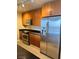 Stainless steel appliances and wood cabinets in this kitchen at 200 W Sahara Ave # 1609, Las Vegas, NV 89102