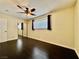 Well-lit bedroom with dark hardwood floors and mirrored closet at 4005 Paul Robarts Ct, Las Vegas, NV 89102