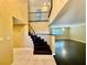 Elegant entryway with dark wood staircase and tile flooring at 4005 Paul Robarts Ct, Las Vegas, NV 89102