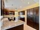 Modern kitchen with dark wood cabinets and granite countertops at 4005 Paul Robarts Ct, Las Vegas, NV 89102