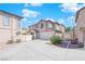 Two-story house with attached garage and a landscaped front yard, viewed from the side at 10596 Corte Sierra St, Las Vegas, NV 89183