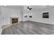 Living room with fireplace, wood-look floors, and ceiling fan at 10596 Corte Sierra St, Las Vegas, NV 89183