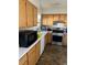 Bright kitchen with wood cabinets, white countertops, and modern stainless steel appliances at 8216 Carmen Blvd, Las Vegas, NV 89128