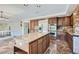 Kitchen with granite island, stainless steel appliances, and access to backyard at 4327 Melrose Abbey Pl, Las Vegas, NV 89141