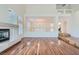 Open living room with hardwood floors and views to dining room at 4327 Melrose Abbey Pl, Las Vegas, NV 89141